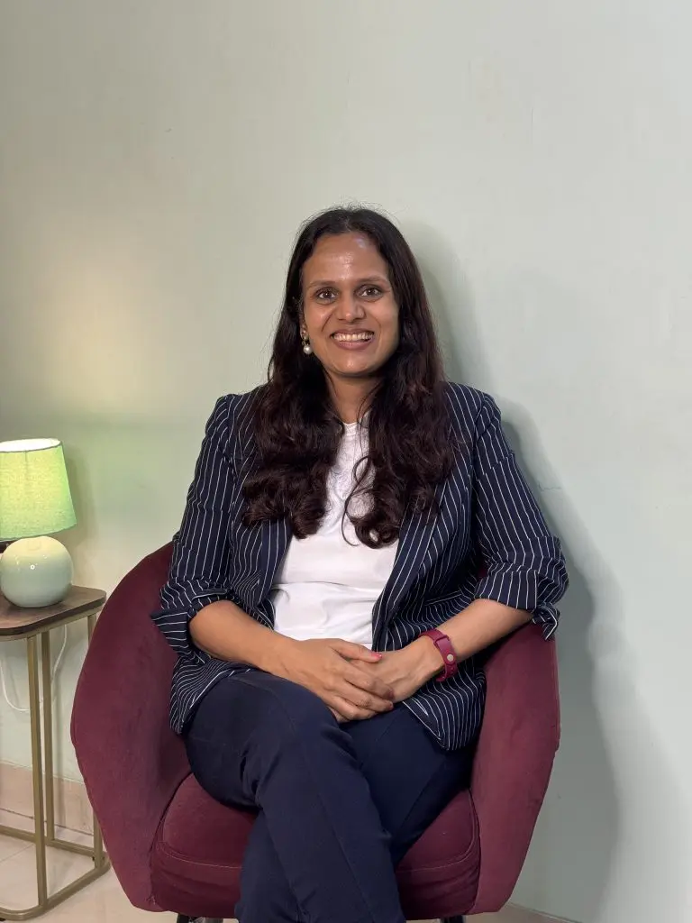 CA Nidhi Jain Sitting in a Chair